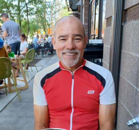 Board of Director candidate Matthew Latimer wearing a red cycling jersey
